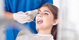 Young woman examined in dental chair